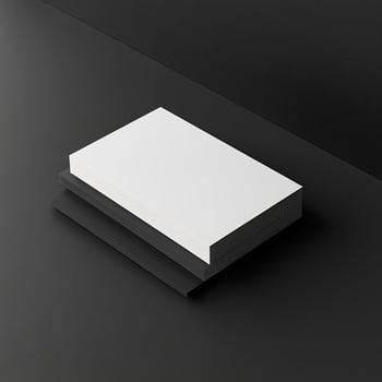 A white book on a black surface photo