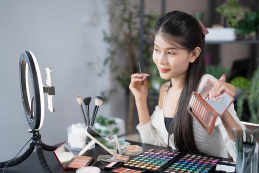 beauty and makeup concept, asian woman using makeup mirror and camera to take photo of her