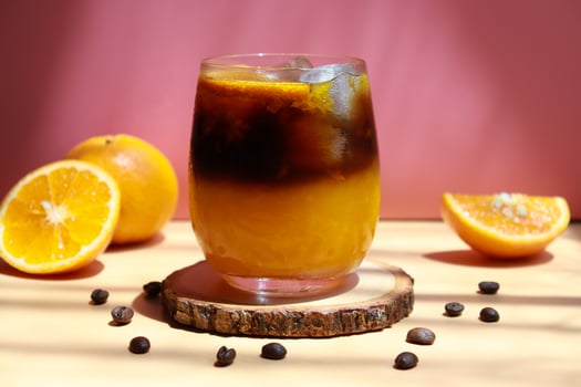 Glass of iced orange americano with fresh orange sliced. photo