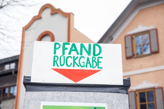 Recycling station sign with red arrow on a german street photo