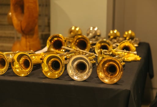 Display of brass musical instruments on black table photo