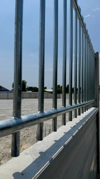 Protective Barrier and Structure A striking image of a modern metallic fence, creating a rigid barrier, highlighting the precision of design, construction, and solid foundation. photo