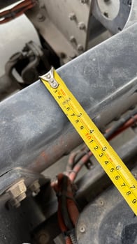 Precise Measurement A detailed close up shows a measuring tape stretched across an industrial component, illustrating precision and attention to detail. photo