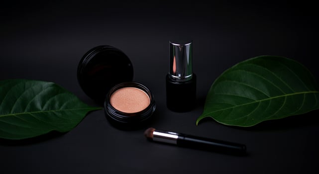 A sleek arrangement of beauty essentials, framed by lush leaves, exudes sophistication photo