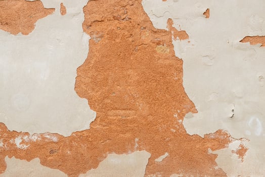 Peeling Wall with Exposed Red Plaster photo