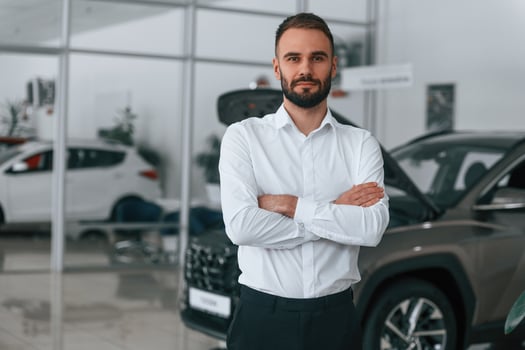 Portrait, of ,beautiful man. Worker ,in formal clothes is in the auto salon photo