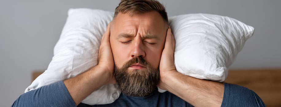 A man with a beard and beard is holding his head with his hands photo