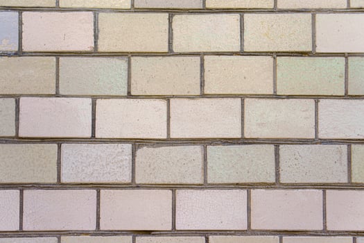 A brick wall with a white brick. The bricks are stacked on top of each other. photo