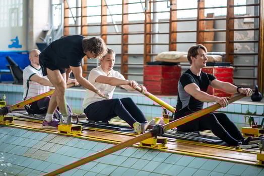 Attentive experienced coach instructs rower crew, correcting posture ensuring synchronized strokes photo