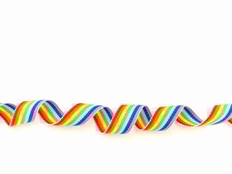 Rainbow cloth ribbon on a white background. Space for text. photo