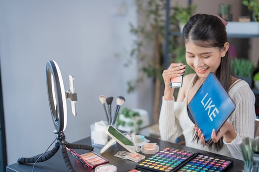 Beauty influencer Asian girl Using Social Media for live streaming on Smartphone like and subscribe to her channel. Like, Follower, Comment photo
