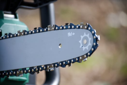 Close-up view of a chainsaw blade, perfect for cutting wood and forestry work, with sharp teeth. photo