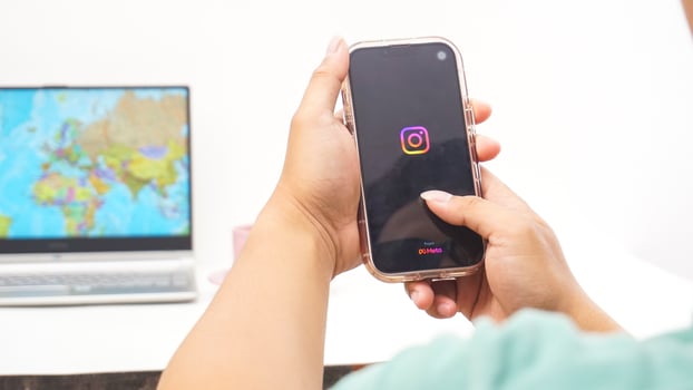 Yogyakarta, Indonesia, 2025 - Man holds smartphone showing Instagram application on the screen isolated on white background photo