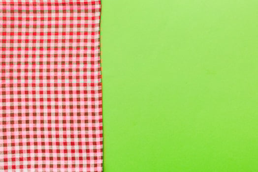 top view red empty kitchen napkin isolated on table background. Folded cloth mockup photo