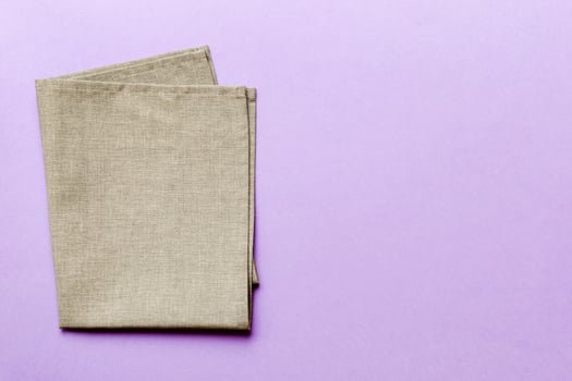 top view with gray kitchen napkin isolated on table background. Folded cloth mockup with copy space, Minimal style photo