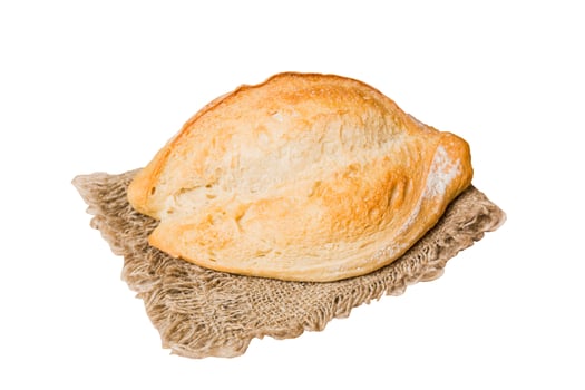 Freshly baked delicious french bread with napkin isolated on white background top view. Healthy bread loaf photo