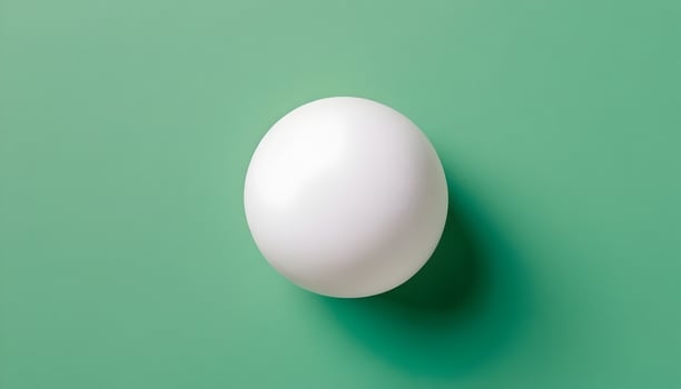 White Sphere on Green Background Creating a Simple and Clean Aesthetic photo
