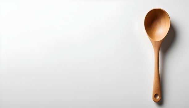 Wooden Spoon on White Background Simple Cooking Utensil Close Up photo