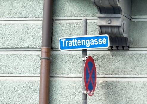 Trattengasse street sign with no parking sign on textured wall photo