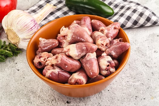 A bowl filled with raw chicken parts photo