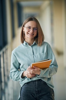 Posing,, holding yellow notepad. Young woman in airport hall photo