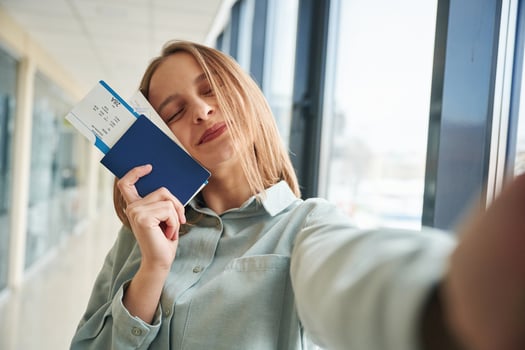 Making selfie, holding ,tickets. Young woman in airport hall photo