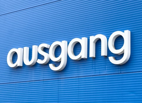 White ausgang sign on blue ribbed wall indicating exit in german photo