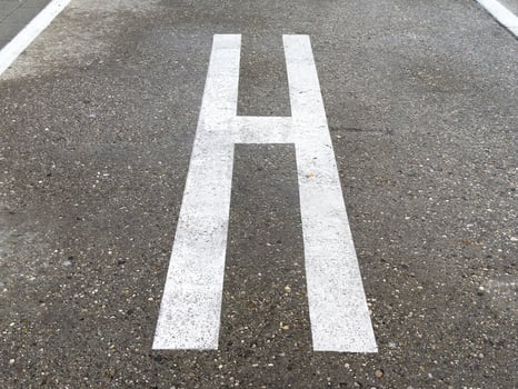 Helicopter landing pad marking on urban concrete surface photo