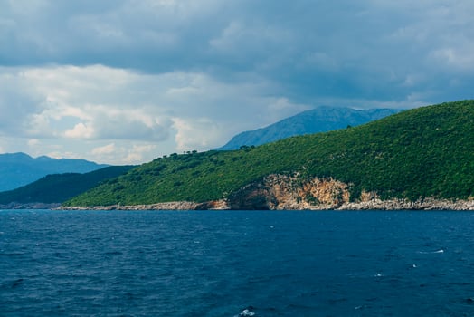 A Tranquil Coastal Landscape Featuring Lush Green Rolling Hills photo