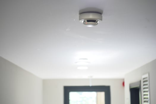 Smoke detector installed in a modern hallway for safety measures photo