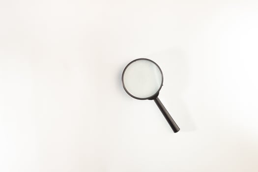 black magnifying glass isolated on white background. photo