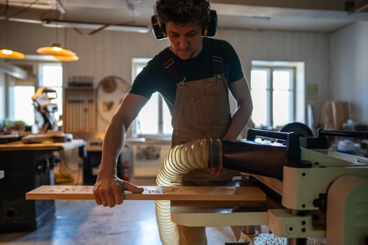 Concentrated craftsman using band saw machine in studio, finalizing project for customer handover photo