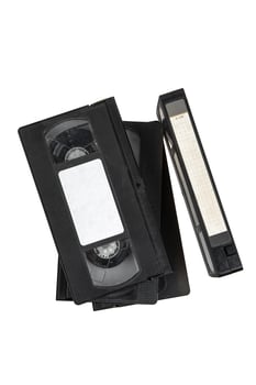 A stack of vintage black VHS tapes arranged together, showcasing a nostalgic piece of media history. photo