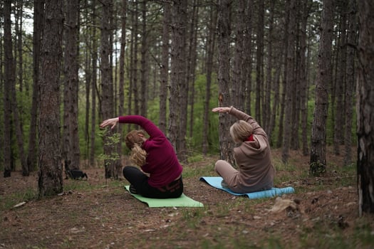 Slow Movement Practice for Women in Forest Nature Surrounded by Tall Pine Trees photo