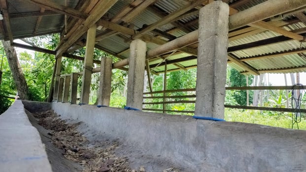 A long wooden trough with dirt and wood photo