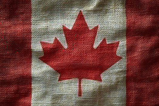 Canadian Flag on Burlap Texture for Patriotic and Rustic Design Themes photo