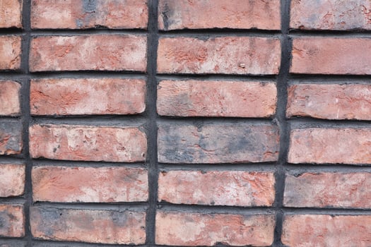A closeup of a textured red brick wall showcasing its detailed appearance and beauty photo