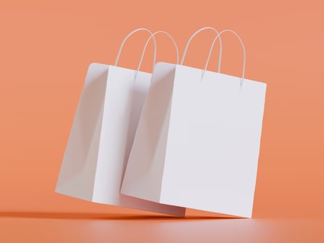 Three white shopping bag on orange background photo