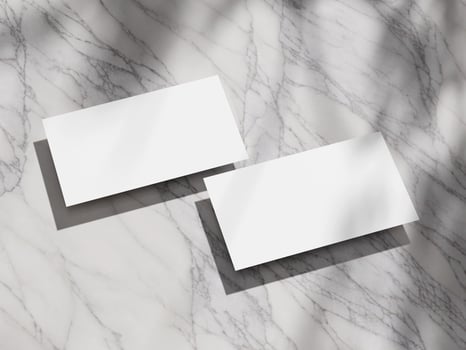 A pair of business cards neatly placed on a marble background, highlighting minimal design. photo