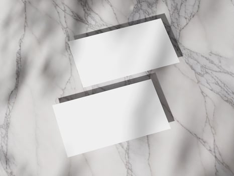 Stylish and simple business card mockup with sharp shadows on a light marble surface. photo