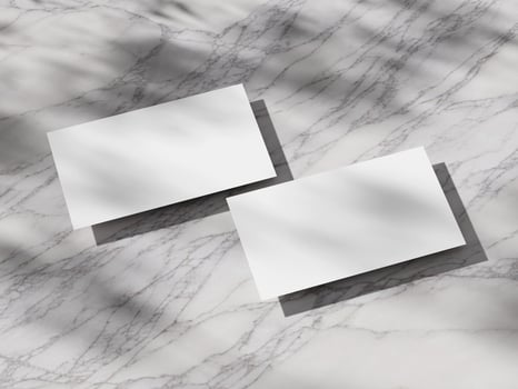 Professional business card mockup with crisp shadows on a luxurious marble texture. photo