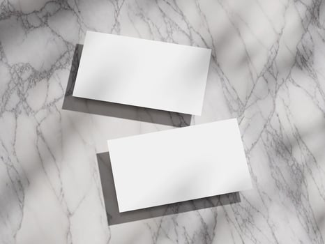 Clean and modern business card mockup set on a marble background, with a focus on shadows. photo
