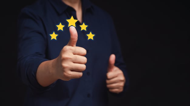 Businessman hands with thumbs up for best excellent services satisfaction client giving a five-star rating photo