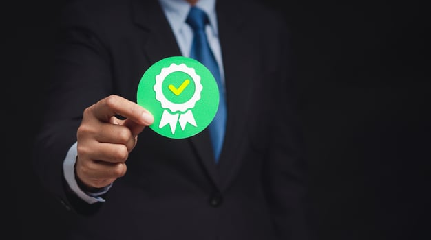 The best quality symbol assurance for a product, service, and ISO certification on a hand businessman photo