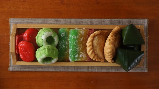 Various kinds of traditional market snacks from Indonesia or jajanan pasar in wooden tray photo