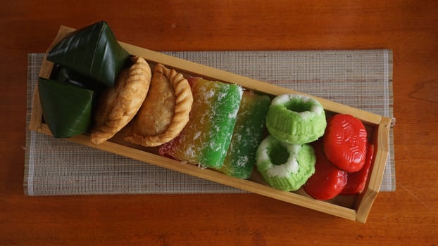 Indonesian traditional market snacks or jajanan pasar in wooden tray photo