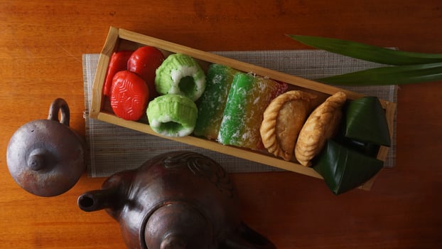Delicious traditional market snacks from Indonesia on wooden tray photo