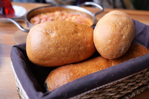 Freshly baked bread rolls served with a warm meal in a cozy restaurant photo