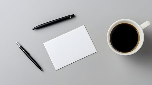 Blank business card mockup on neutral desk surface with coffee and pen photo