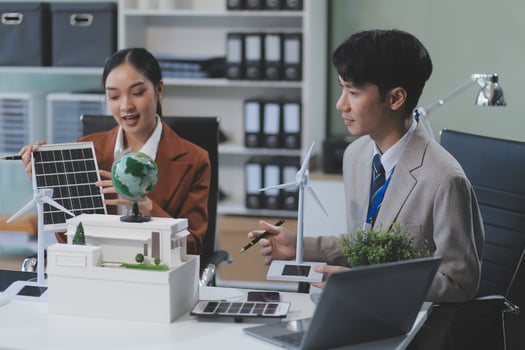 Asian business people working in office with laptop and solar panel photo